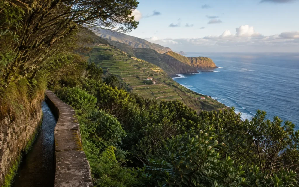 Levada path, terraced hillsides and the Atlantic ocean on Madeira